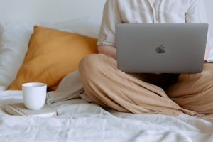 woman on bed with laptop